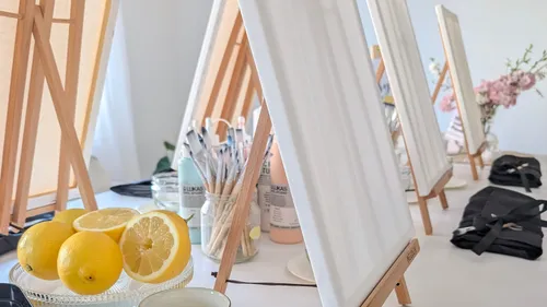 Canvases and lemons on a painting table.