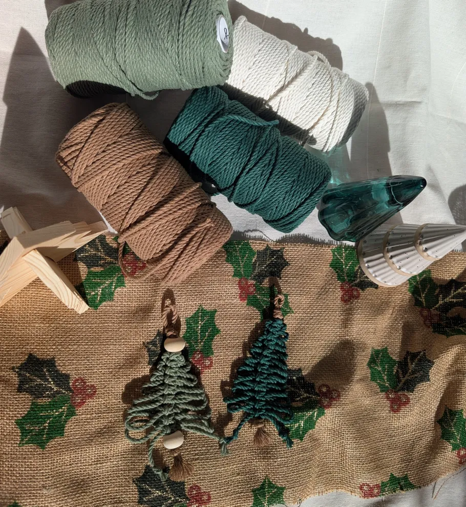 Yarn spools and decorations on festive fabric.