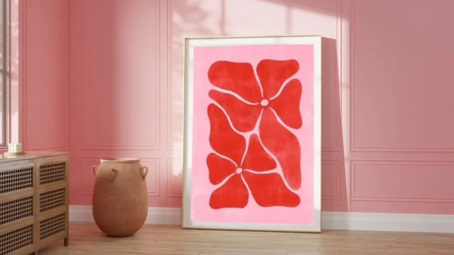 Abstract red flower artwork on pink wall.