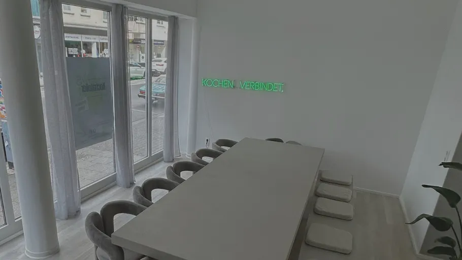 Meeting room with long table and chairs.
