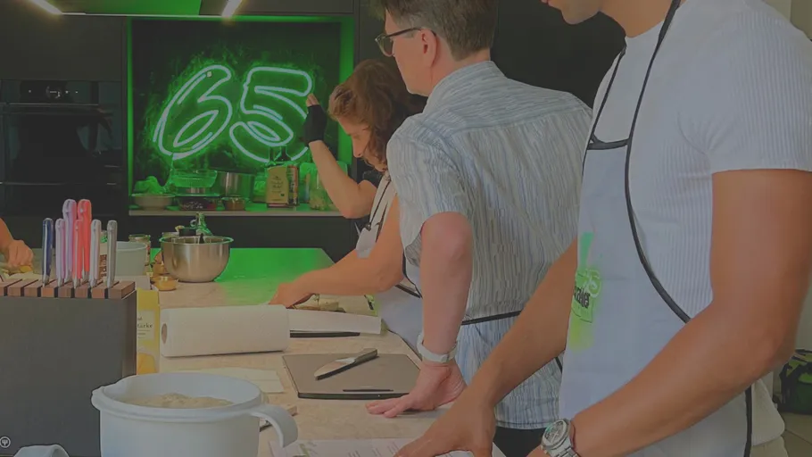 People cooking in a modern kitchen.