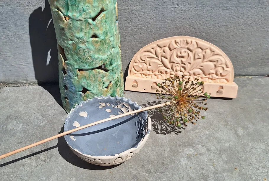 Ceramic objects displayed on concrete floor.