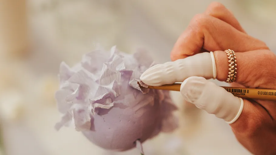 Hand painting purple ornament with brush.