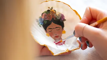 Hand painting portrait on a large shell.