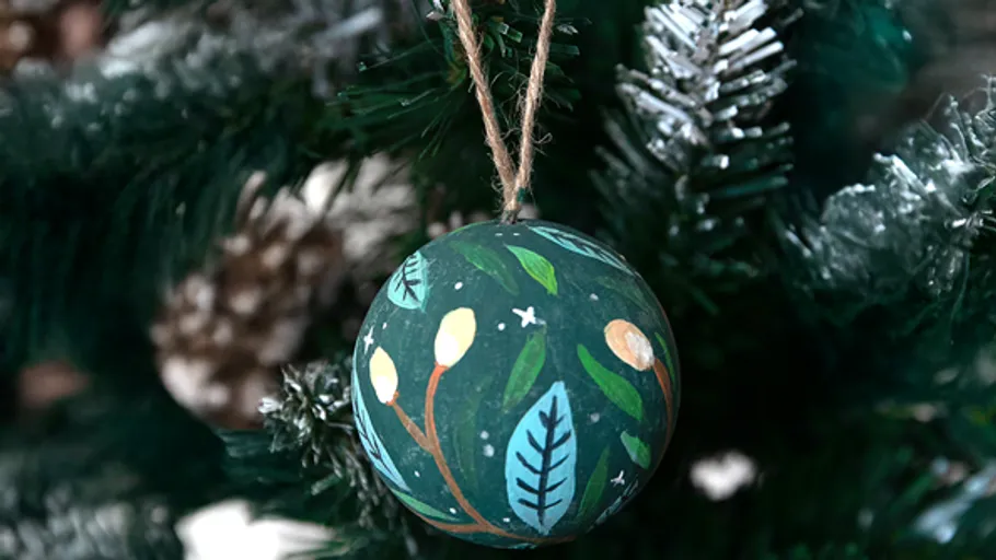 Decorated bauble hanging on Christmas tree.