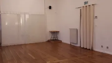 Empty room with wooden floor and white walls.