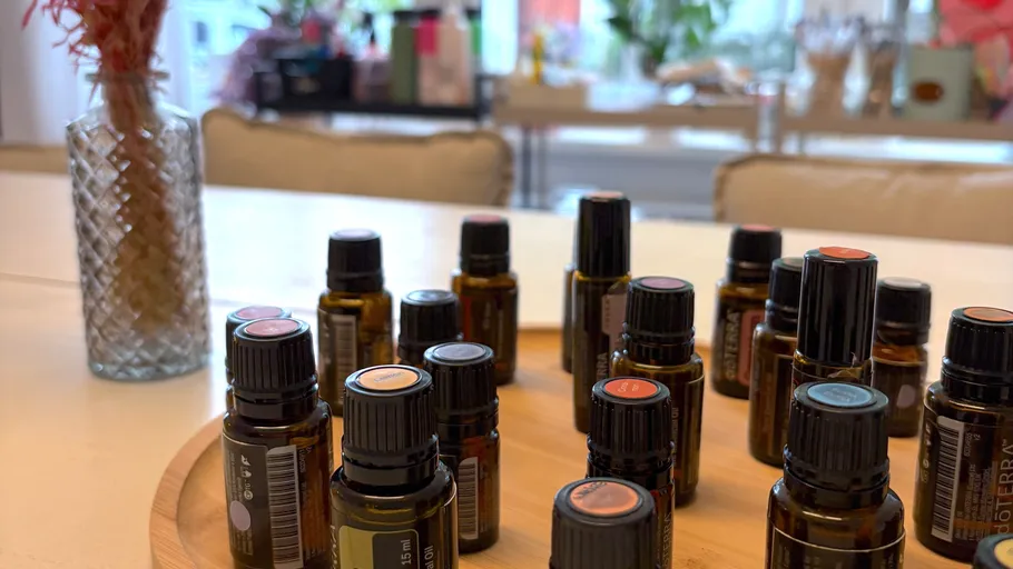 Essential oil bottles arranged on a wooden tray.