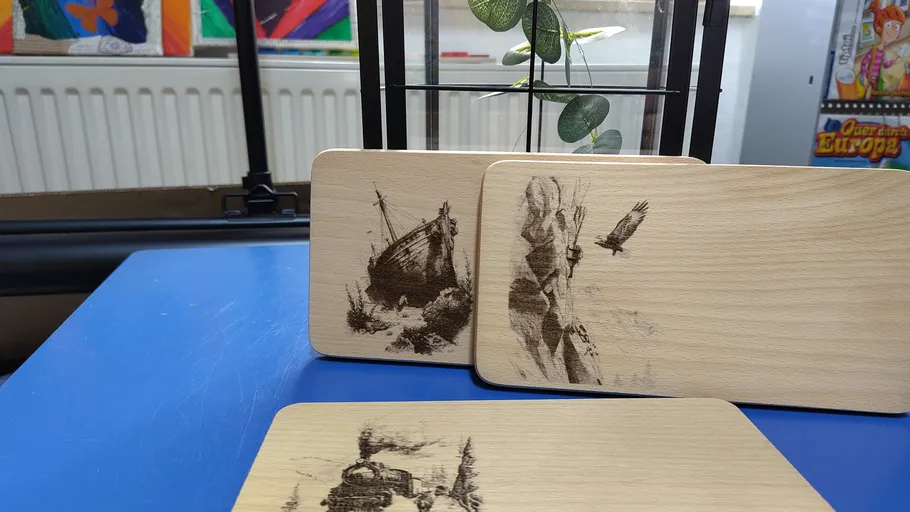 Wooden coasters with engraved designs on table.