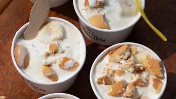 Cups of banana pudding with cookie pieces.
