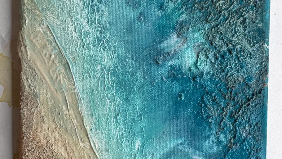 Textured blue and sandy abstract painting.