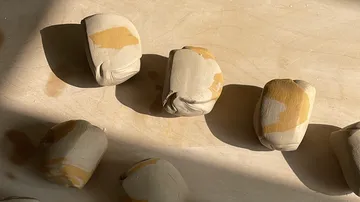 Tonstücke auf einer Holzfläche angeordnet.