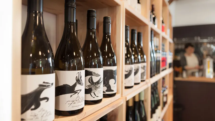 Wine bottles displayed on wooden shelves.