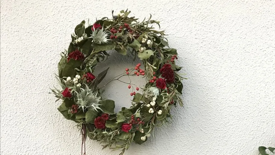 Decorative wreath with flowers on a wall.