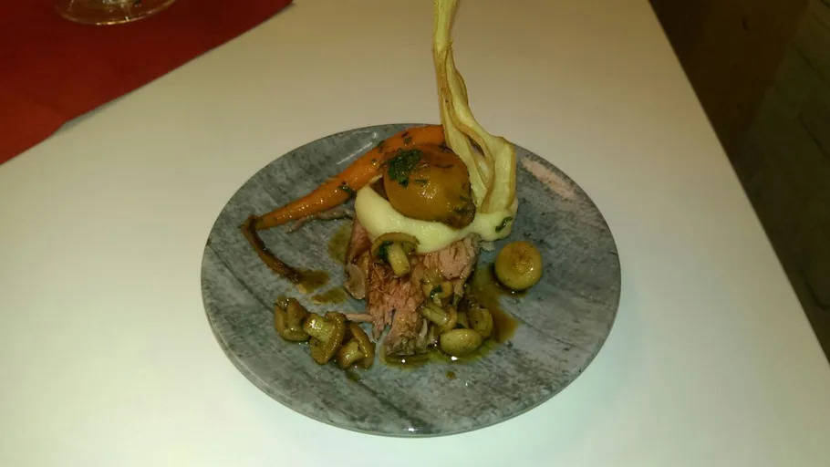 Gourmetgericht mit Fleisch, Gemüse auf einem Teller.