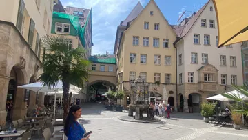 People walking in a European courtyard.