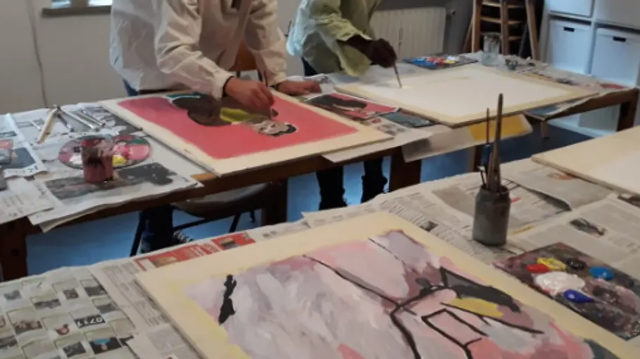 Two people painting at a table.