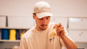 Man eating in a casual indoor setting.