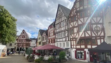 Half-timbered buildings in a quaint town square.
