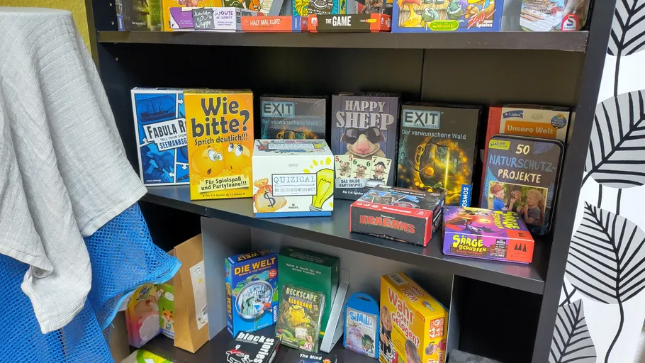 Shelf with various games and puzzles displayed.