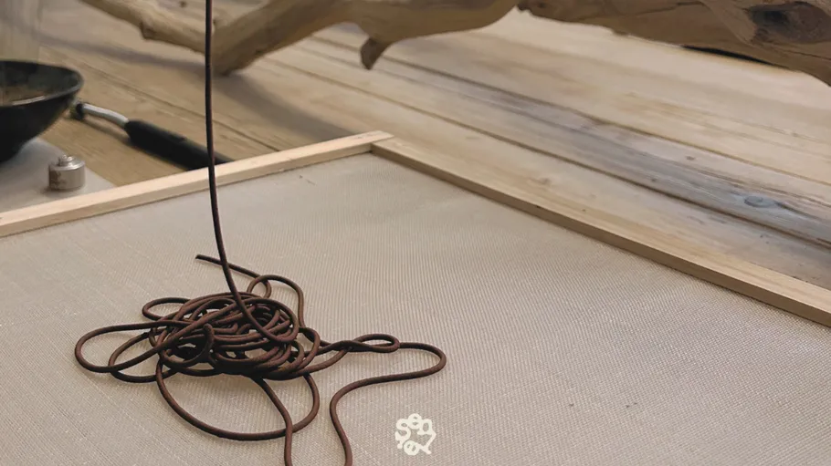 Chocolate extruded onto a wooden tray.
