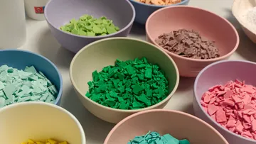 Colorful plastic flakes in bowls on a table.
