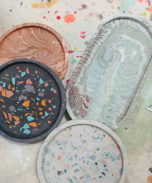 Four decorative trays with colorful patterns.