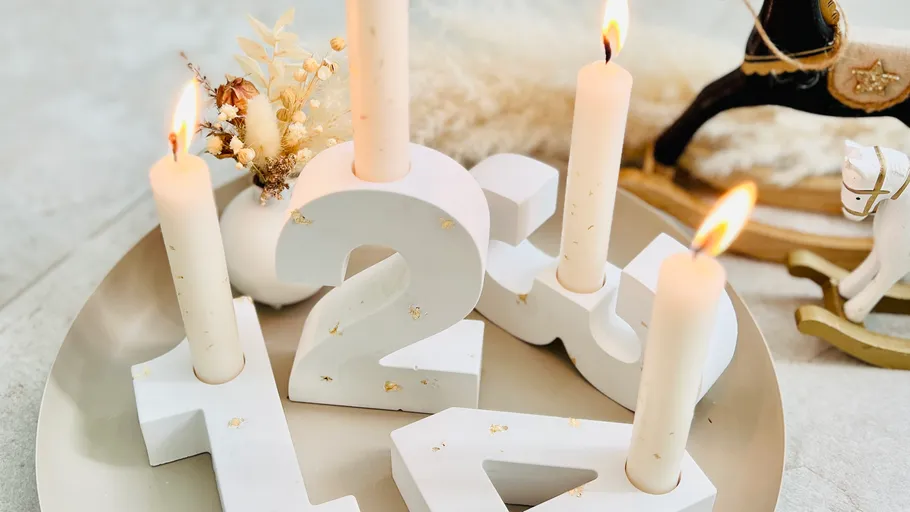 Candles in number holders on a tray.
