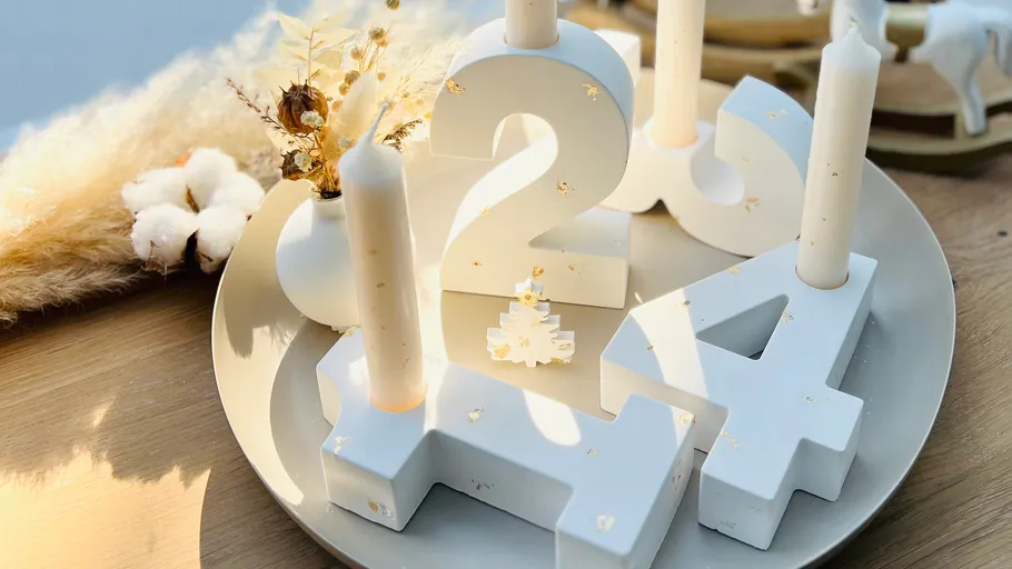 Number-shaped candle holders on decorative plate.
