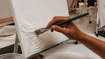 Hand painting on canvas with brush.