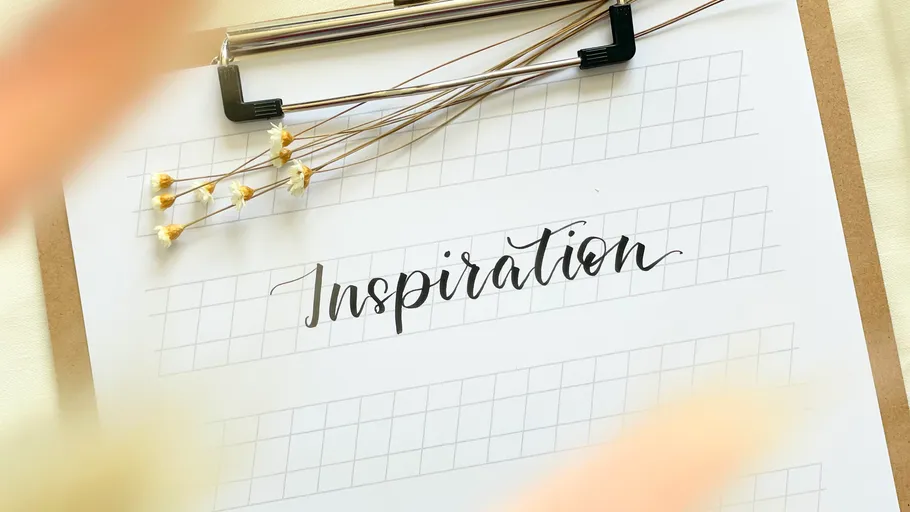 Clipboard with calligraphy practice sheet, flowers.