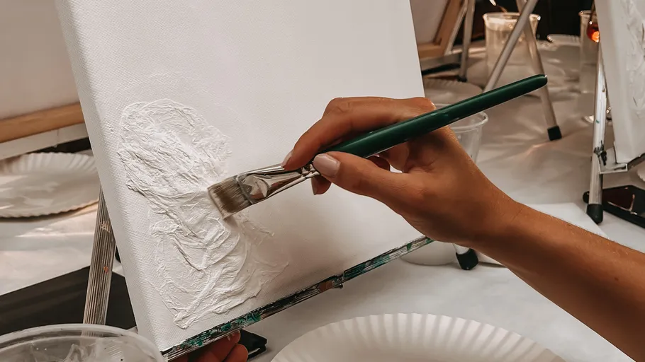Hand painting on canvas in studio.