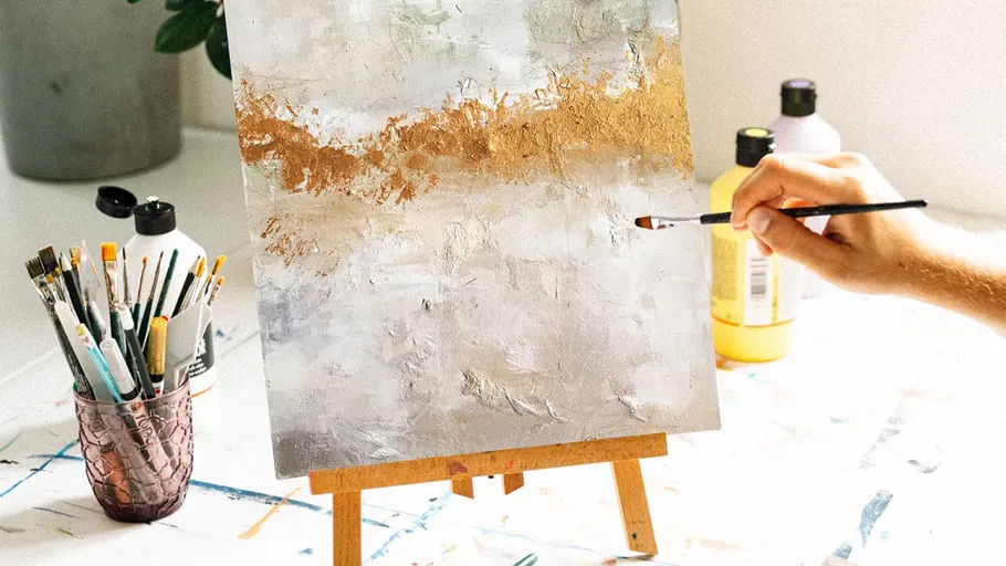 Hand painting abstract art on easel.