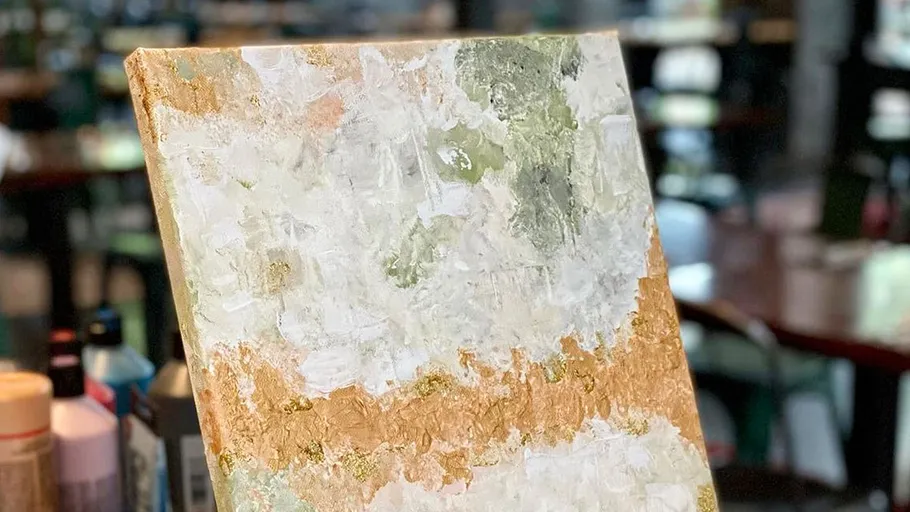 Abstract painting with gold and white textures.