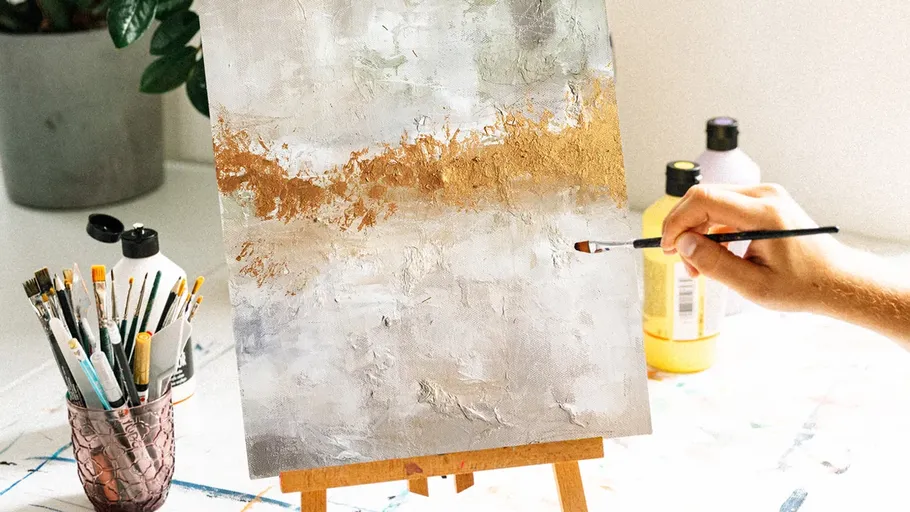 Hand painting abstract art on canvas easel.