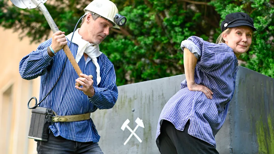 Two miners in striped shirts posing outdoors.