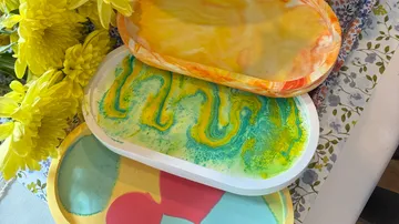 Colorful molded trays on floral table cloth.
