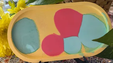 Colorful abstract shapes on a yellow tray.