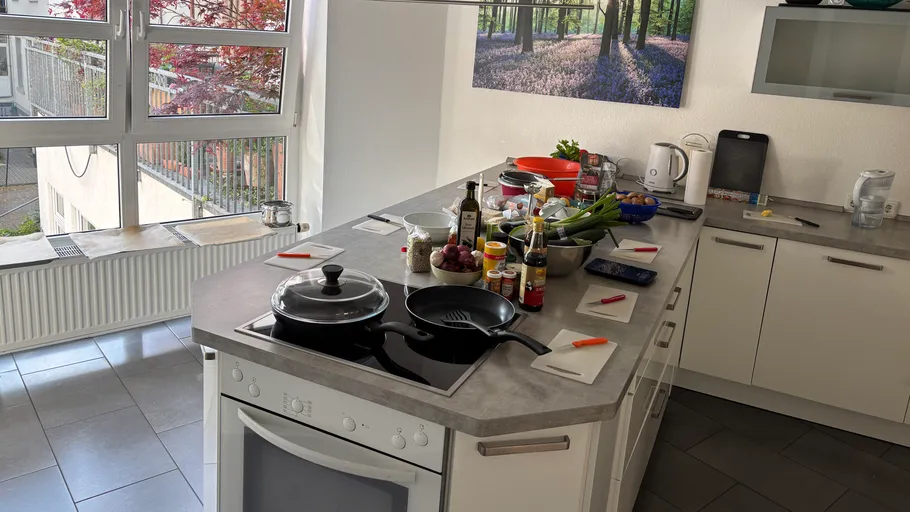 Kitchen counter with ingredients and cookware.