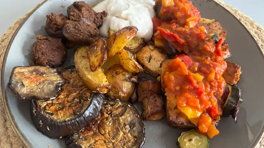 Plate with roasted vegetables and sauce.
