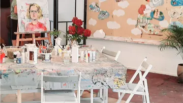 Art studio with painting supplies and easel.