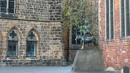 Animal statue beside historic brick building.