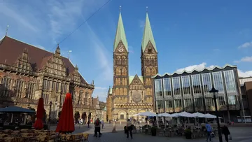 Cathedral with twin spires in city square.