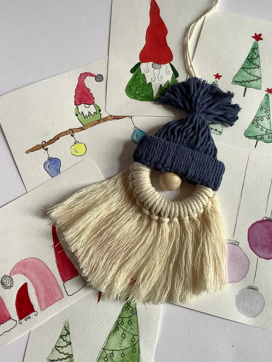 Handmade gnome ornament on Christmas-themed cards.