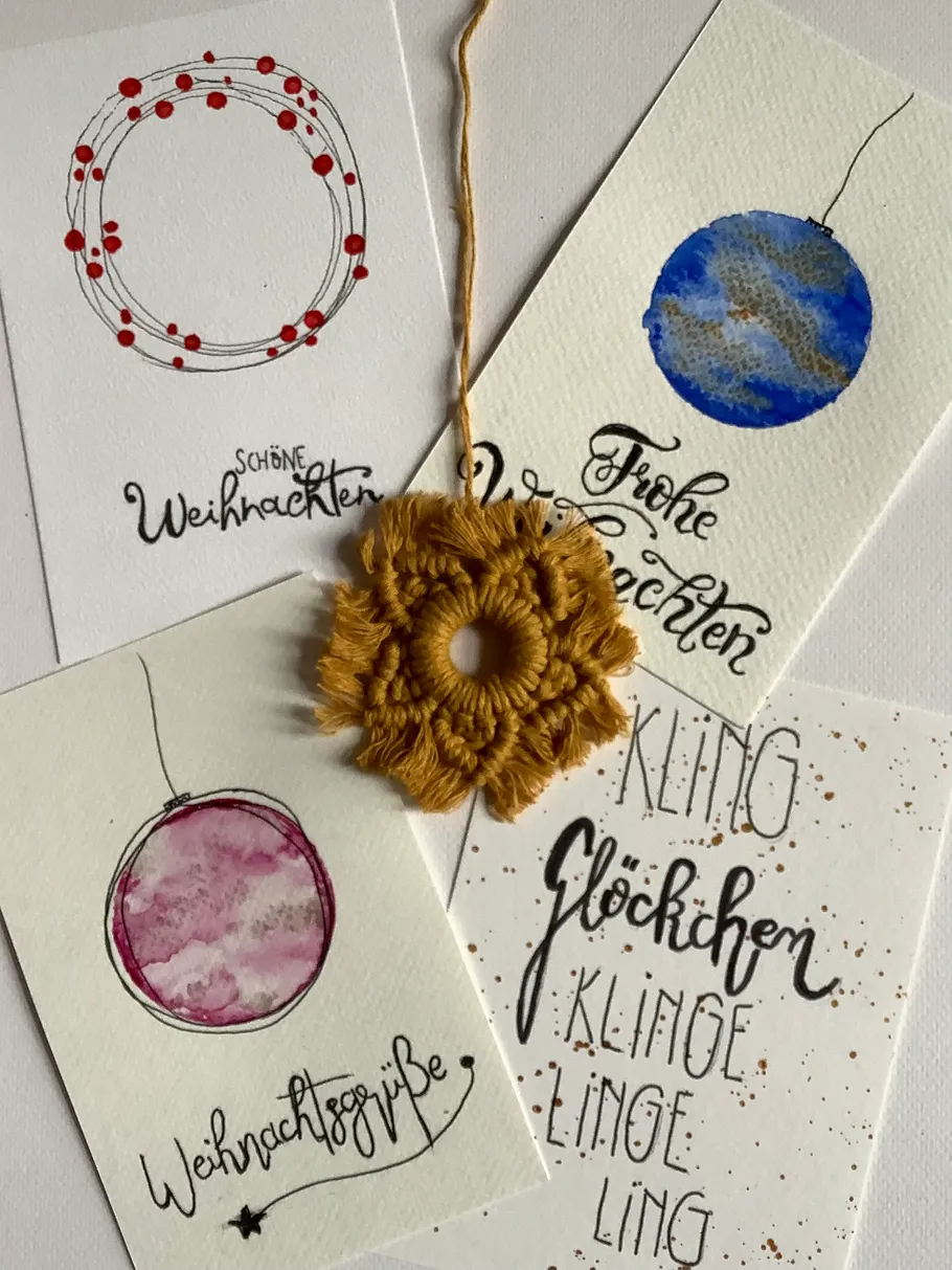 Four Christmas cards with handwritten messages.