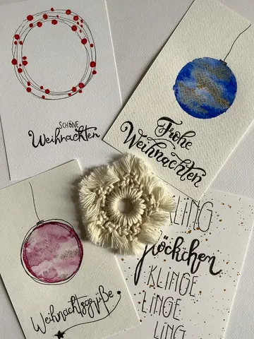 Handmade Christmas cards with artistic designs.