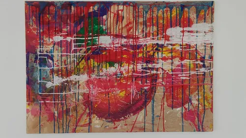 Abstract painting with colorful drips on canvas.