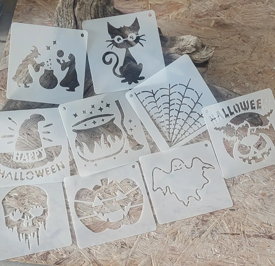 Halloween-themed stencils arranged on wooden surface.
