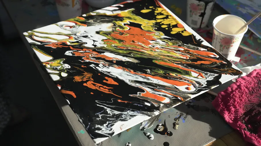 Colorful abstract painting on tilted canvas.