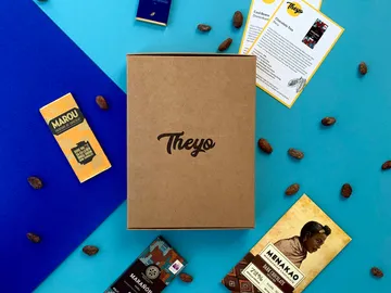 Brown box with chocolate on a blue background.