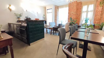Cozy cafe with tables and chairs, brick walls.